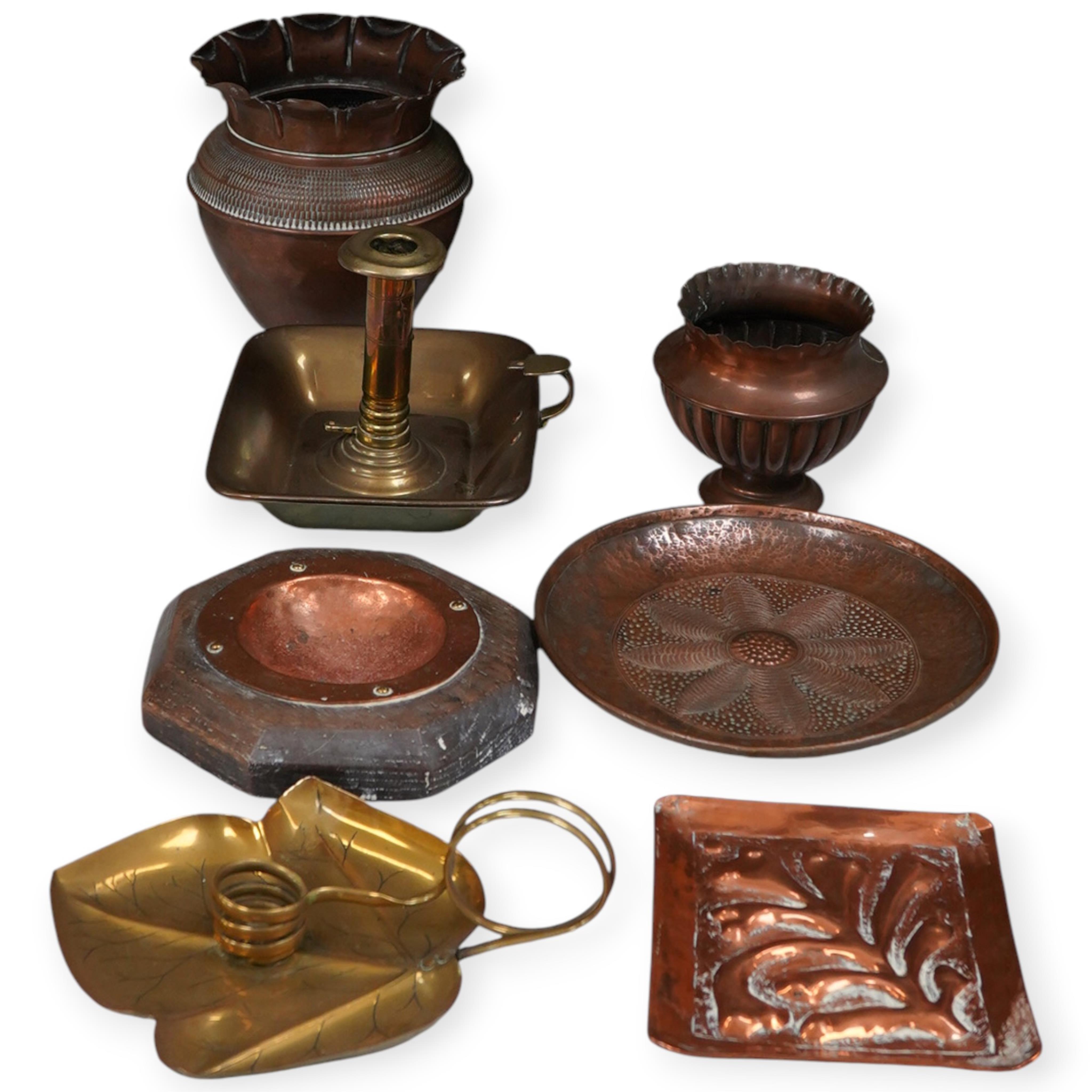 A group of brass and copper Arts & Crafts vases, including a J Sankey leaf candle holder